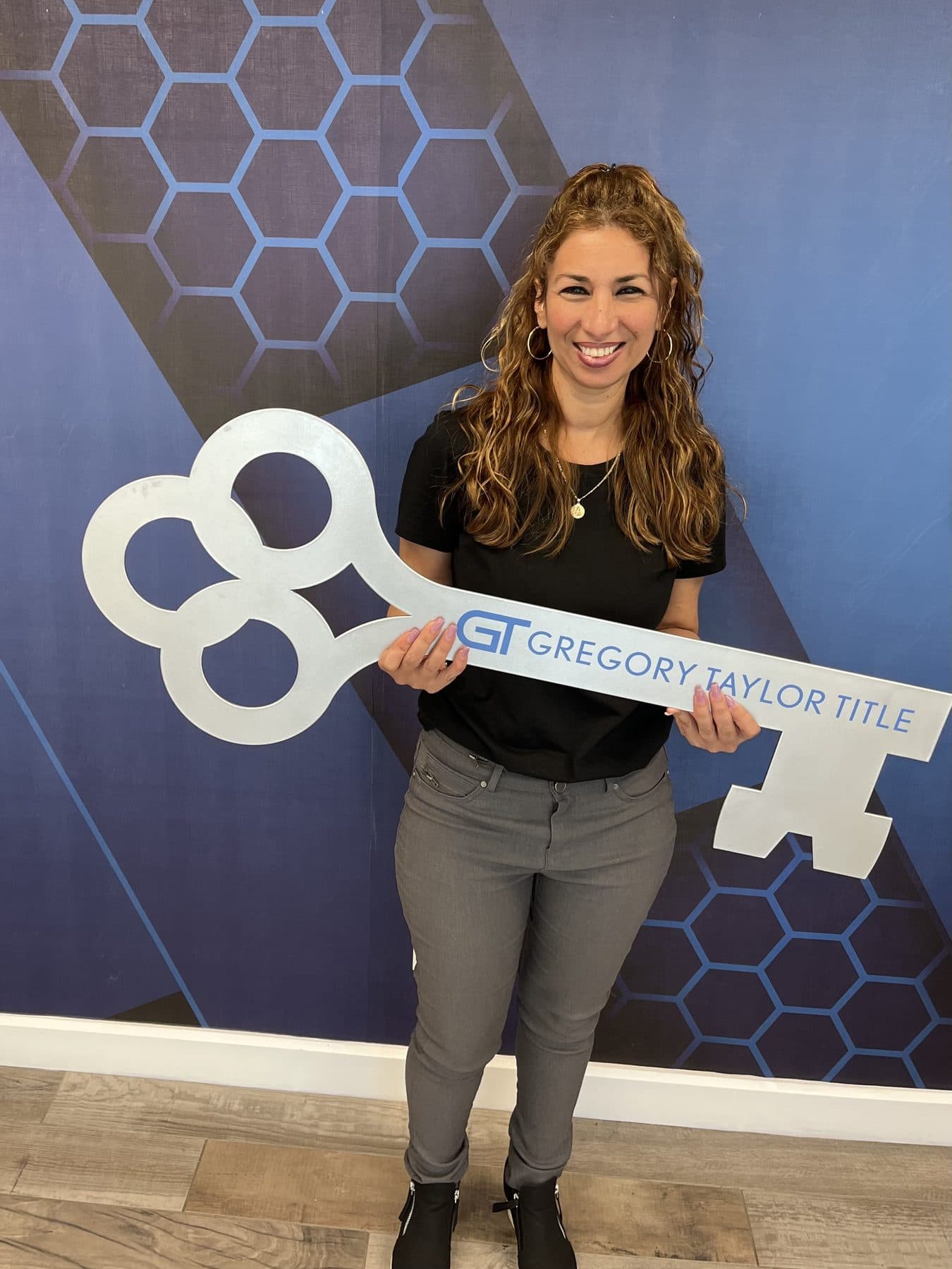 A client holding a Gregory Taylor Title closing key